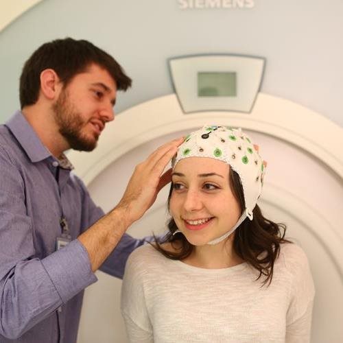 researcher and study participant with MRI cap at Baycrest 