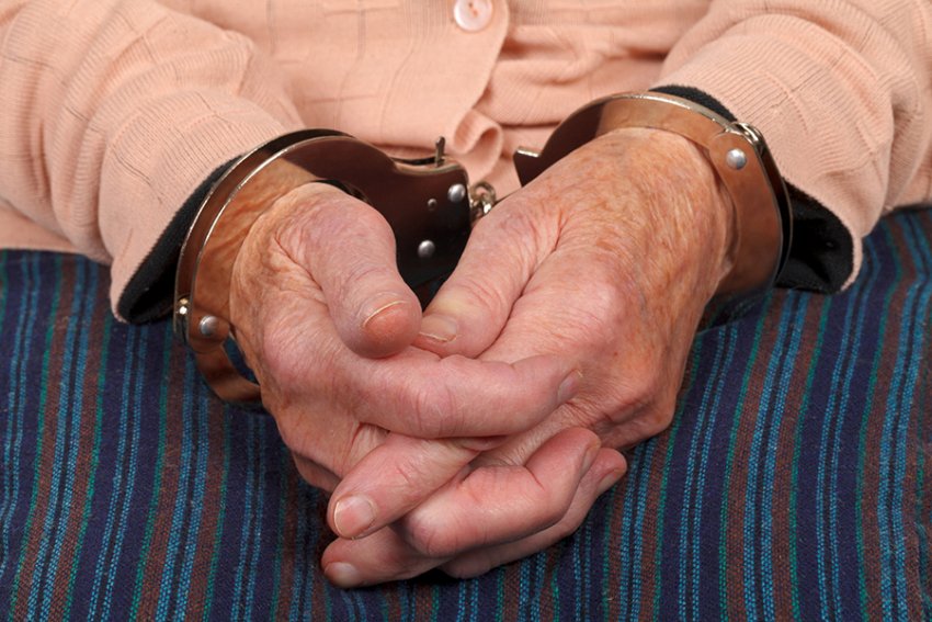 elderly woman in handcuffs