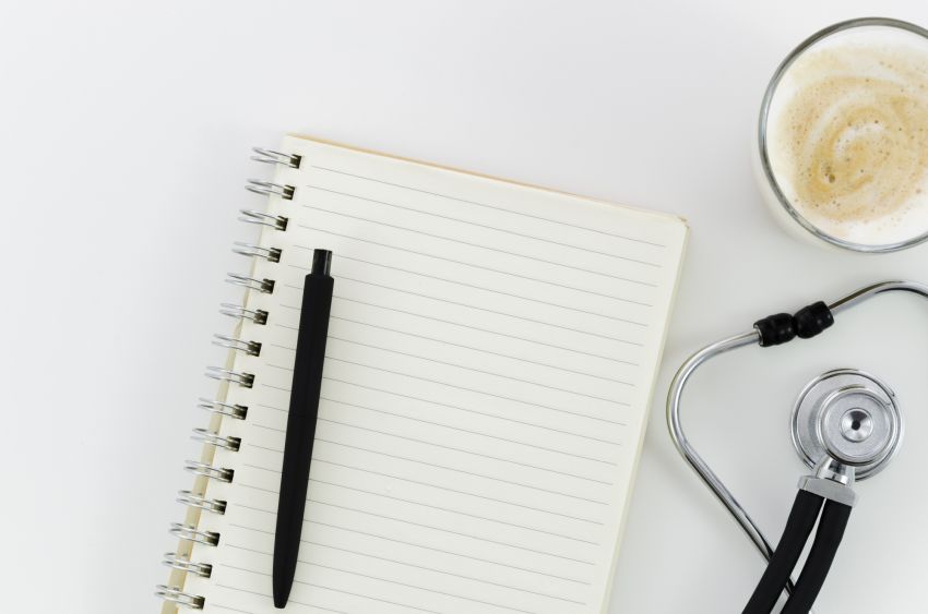 notepad with stethoscope coffee cup