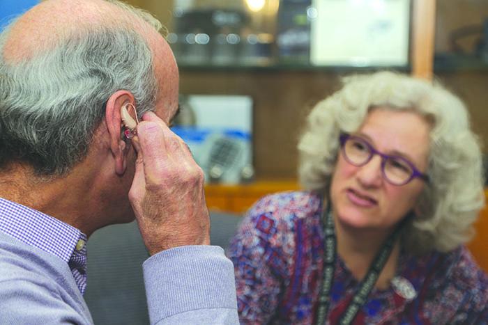 older adult testing hearing aid