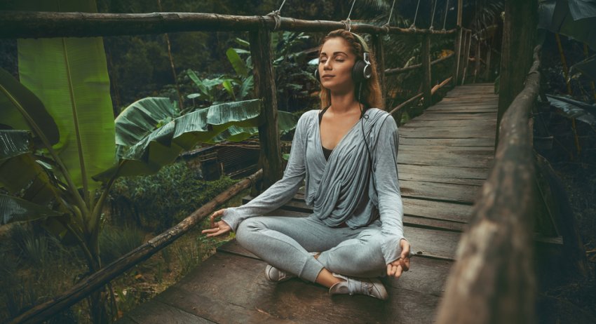 woman meditating and listening to music 